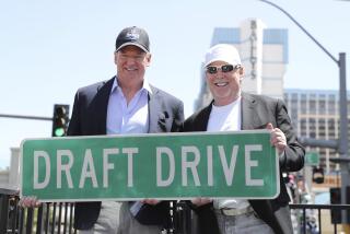 NFL Commissioner Roger Goodell, left, poses with Raiders owner Mark Davis and a Draft Drive ceremonial street sign