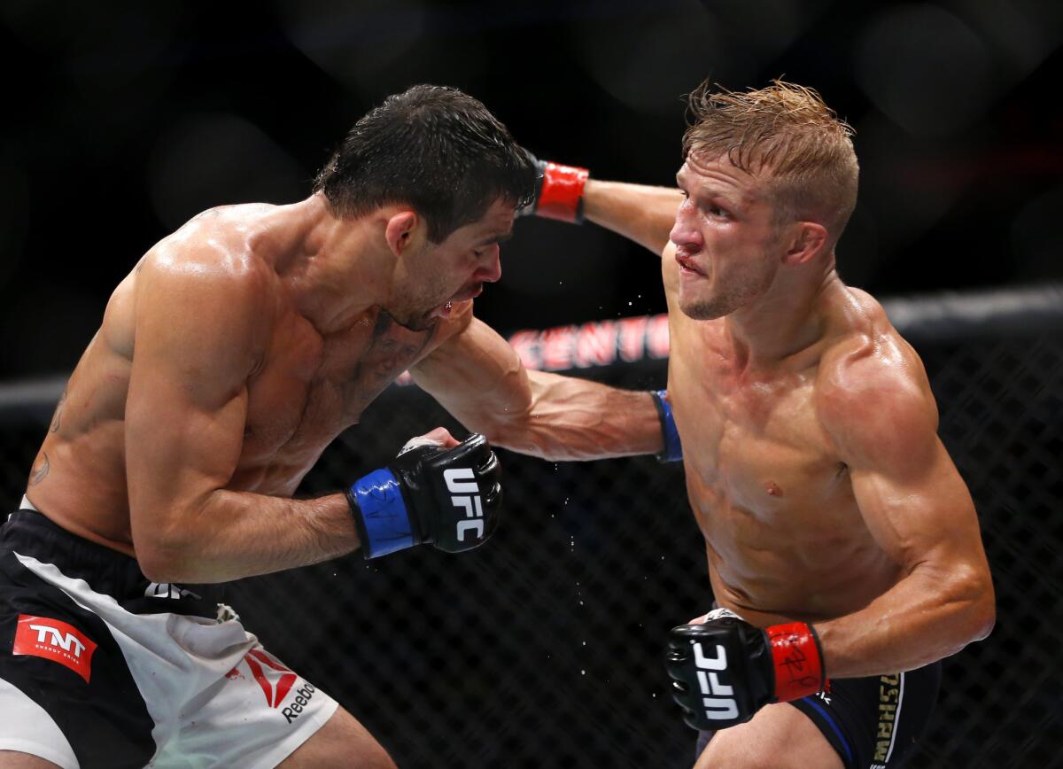 T.J. Dillashaw, right, throws a punch to the head of Renan Barao during their bantamweight championship fight at UFC Chicago on July 25, 2015.