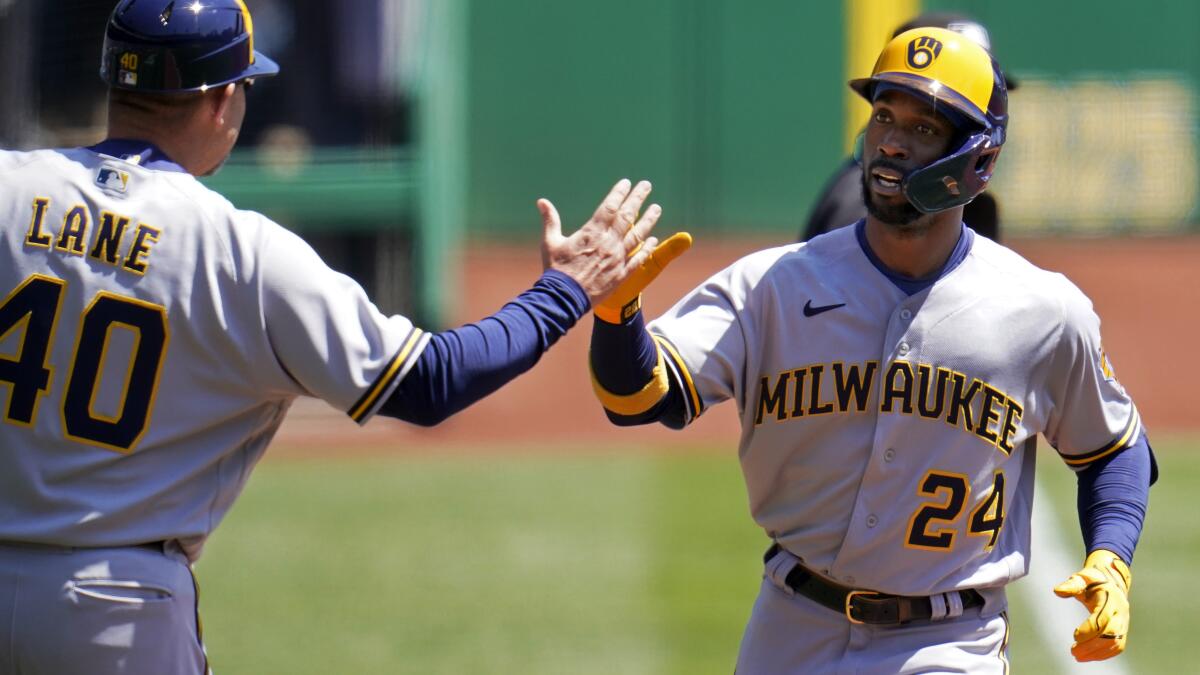 Milwaukee Brewers designated hitter Andrew McCutchen reacts as he