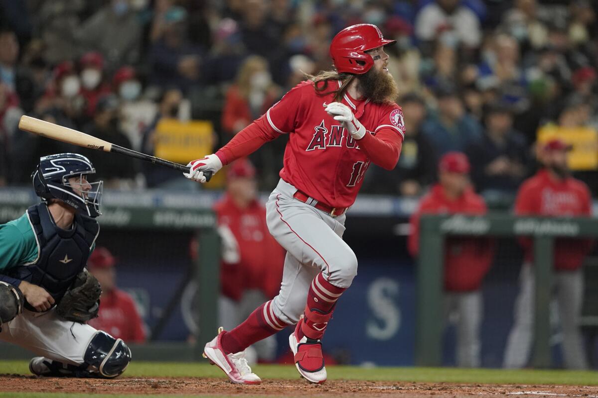 The Angels' Brandon Marsh and Mariners catcher Tom Murphy watch Marsh's two-run double in the third inning Oct. 1, 2021.