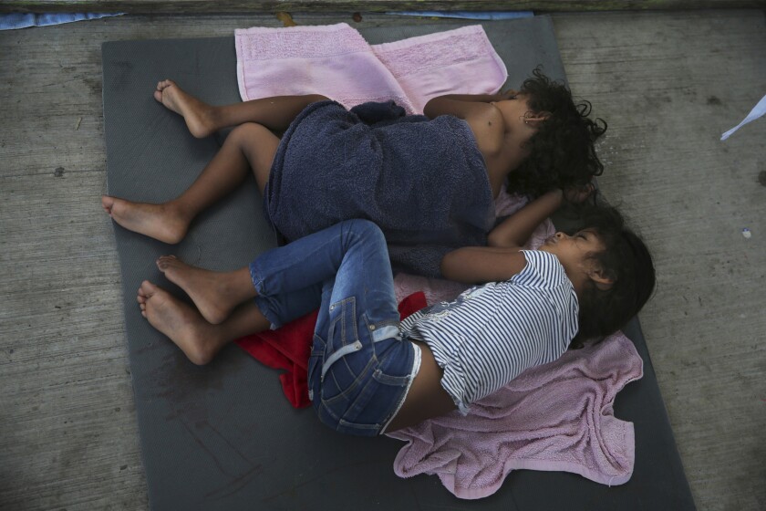 Migrant children sleep on a mattress on the floor of the AMAR migrant shelter in Nuevo Laredo, Mexico, in this July 17 file photo.
