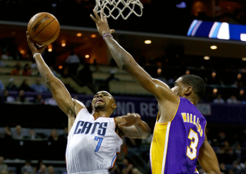 Ramon Sessions, shown driving on the Lakers' Shawne Williams on Saturday night, is finishing a two-year, $10-million deal he signed with the Charlotte Bobcats after declining a one-year, $4.55-million player option that would have kept him with L.A. for the 2012-13 season.