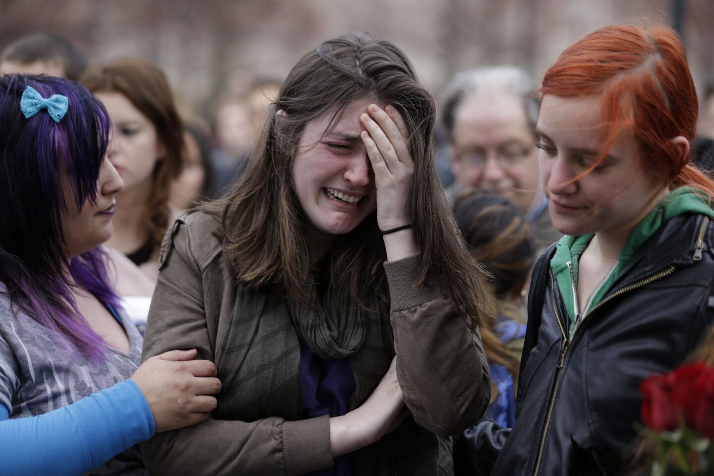 Emma MacDonald, 21, center, cries at the Boston Common vigil Tuesday for the victims of the marathon bombings.