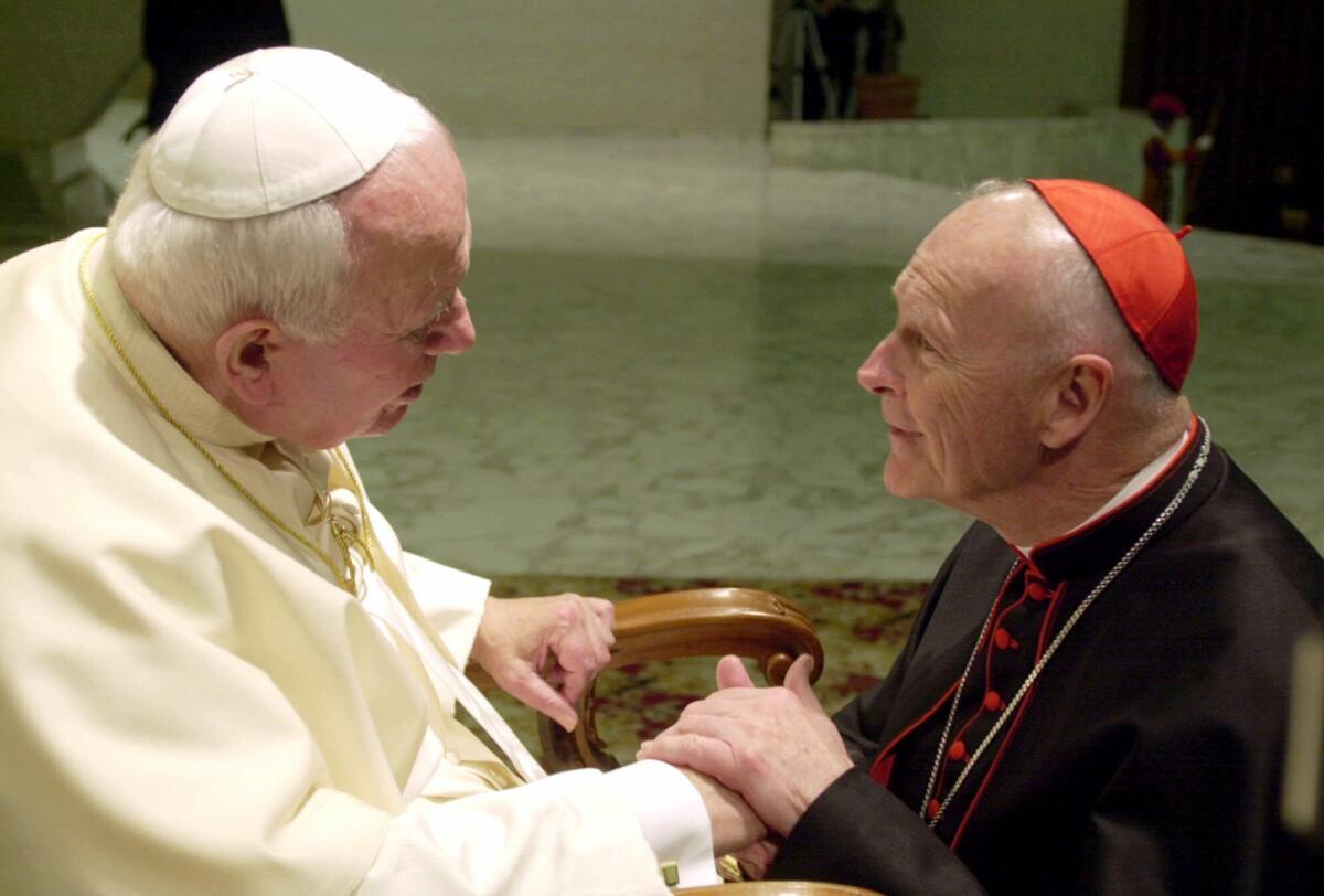 Cardinal Theodore Edgar McCarrick shakes hands with Pope John Paul II in 2001.