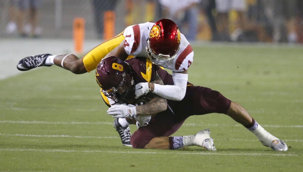 USC cornerback Isaiah Langley tackles Arizona State receiver D.J. Foster during a game on Sept. 26, 2015.