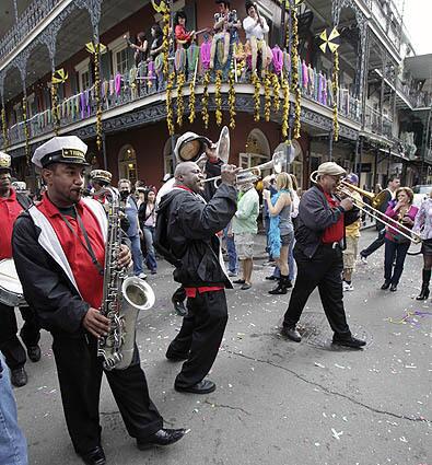 The Treme Jazz Band marches through the French Quarter in New Orleans on Mardi Gras, the last day of the Carnival season ending at midnight, a daylong celebration of parades, marching groups and people in costumes.