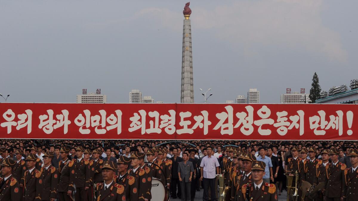 Participants stand behind a military band in Pyongyang, North Korea, on Sept. 13 during a celebration rally after the country's successful test of a nuclear warhead.