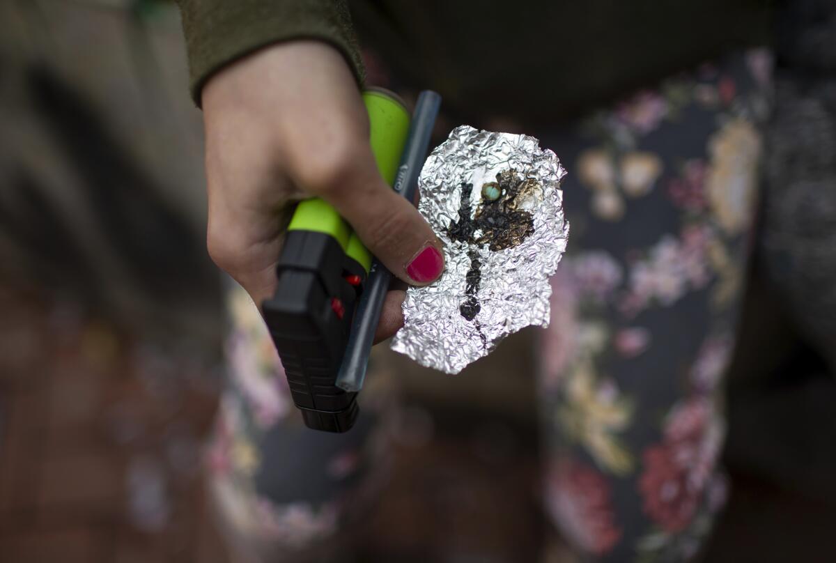 A person holds drug paraphernalia.