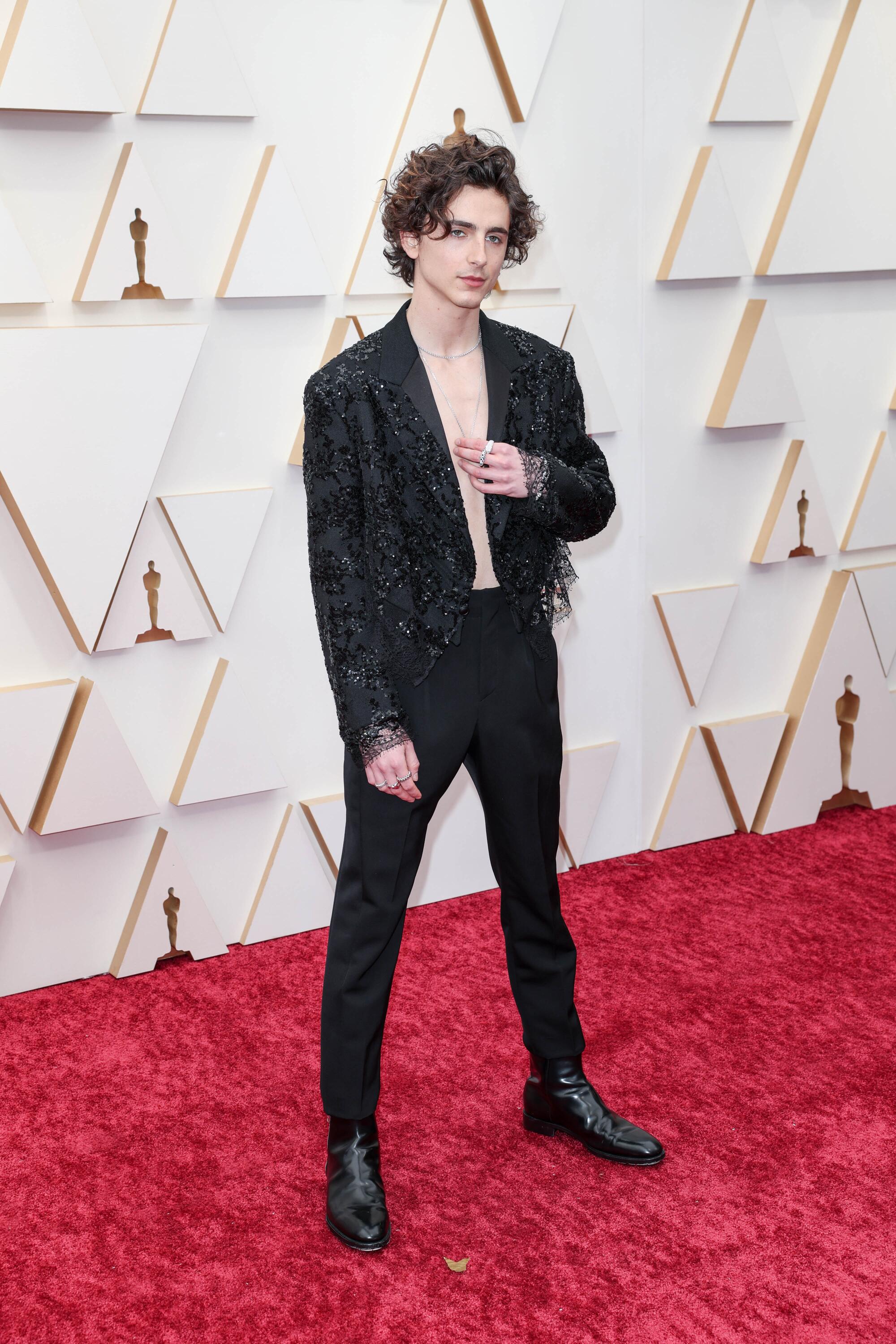 A man shows off his Oscars look on the red carpet.