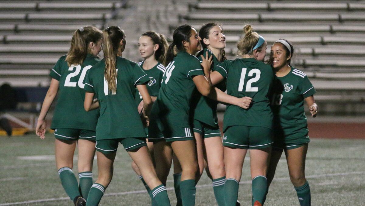 LCC senior Gracey Walke (third from right) celebrates with teammates after scoring.