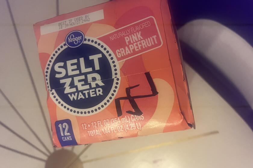 Closeup of a box of seltzer water with a symbol written on it in marker.