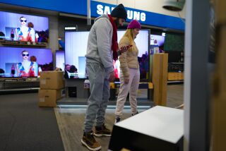 Encinitas, CA - November 25: On Friday, Nov. 25, 2022 at the Best Buy in Encinitas, CA., Joao Neves and his wife, Pamela Borges (cq) shopped for the best deal on a large screen television set. The couple settled on a Samsung 55-inch television that they earlier compared prices from other local stores. (Nelvin C. Cepeda / The San Diego Union-Tribune)