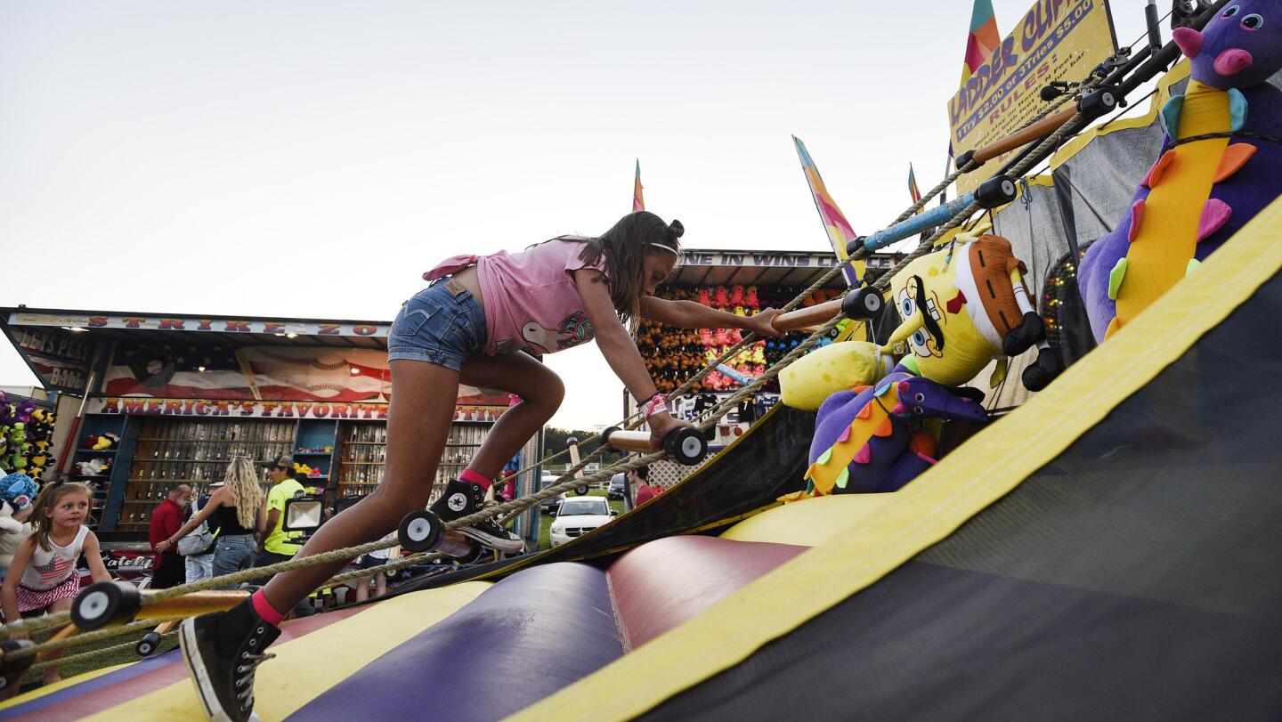 Savannah Burns, 7, of Winfield, tries the Ladder Climb at the Winfield fire company carnival Wednesday, July 10, 2019.