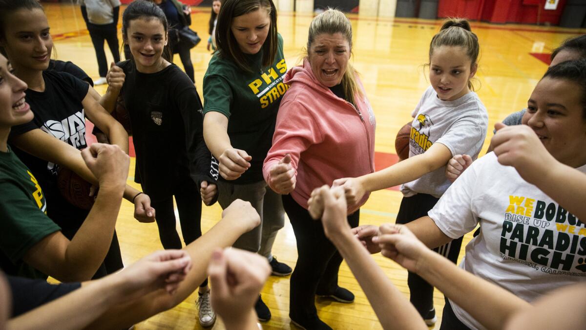 Coach Sheila Craft and the Paradise High School Bobcats do a cheer before starting practice Nov. 15. It was the team's first practice since being displaced by the Camp fire.