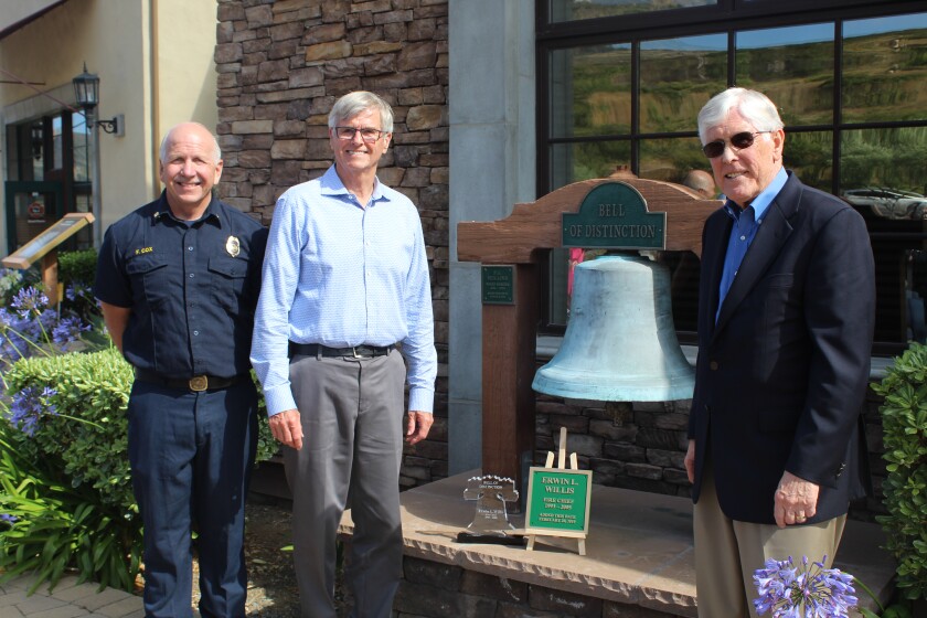 Retired Fire Chief Erwin Willis, middle, is honored with the Bell of Distinction. Chief Fred Cox and RSF Fire Protection District board President Jim Ashcraft helped celebrate his career on June 19.