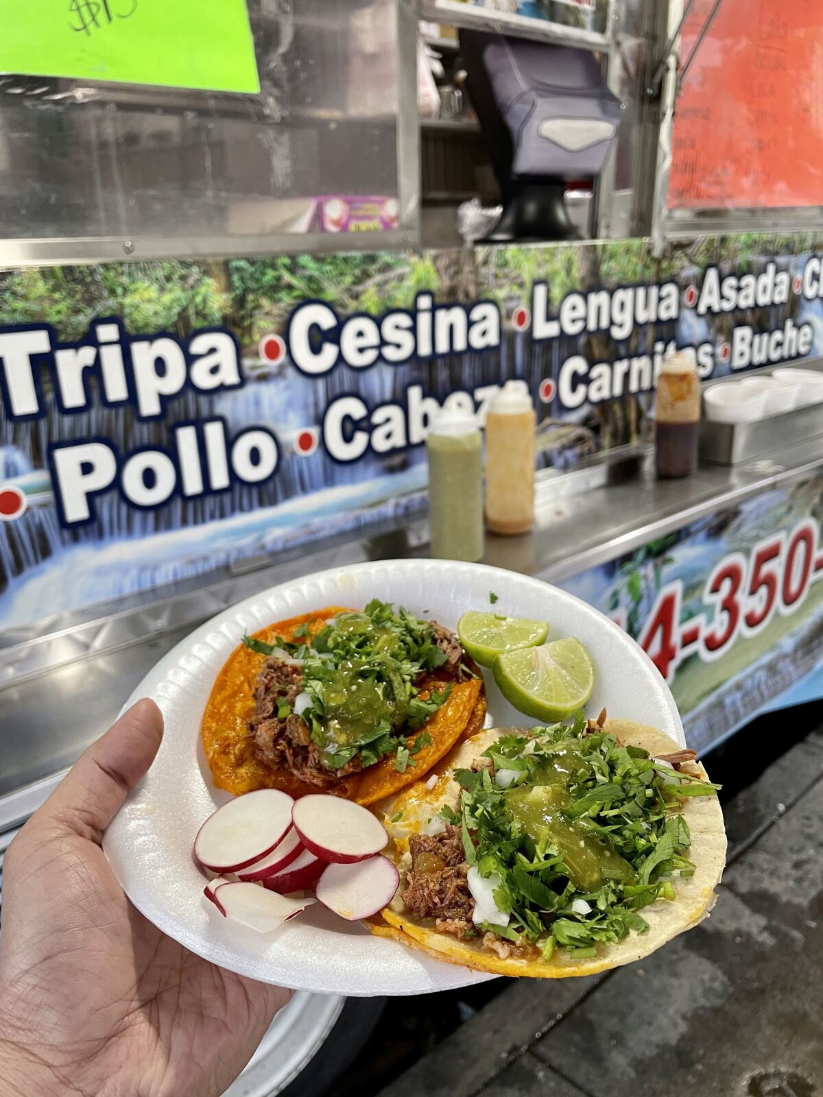 The red and regular goat birria tacos at La Cascada, a food truck in Santa Ana.