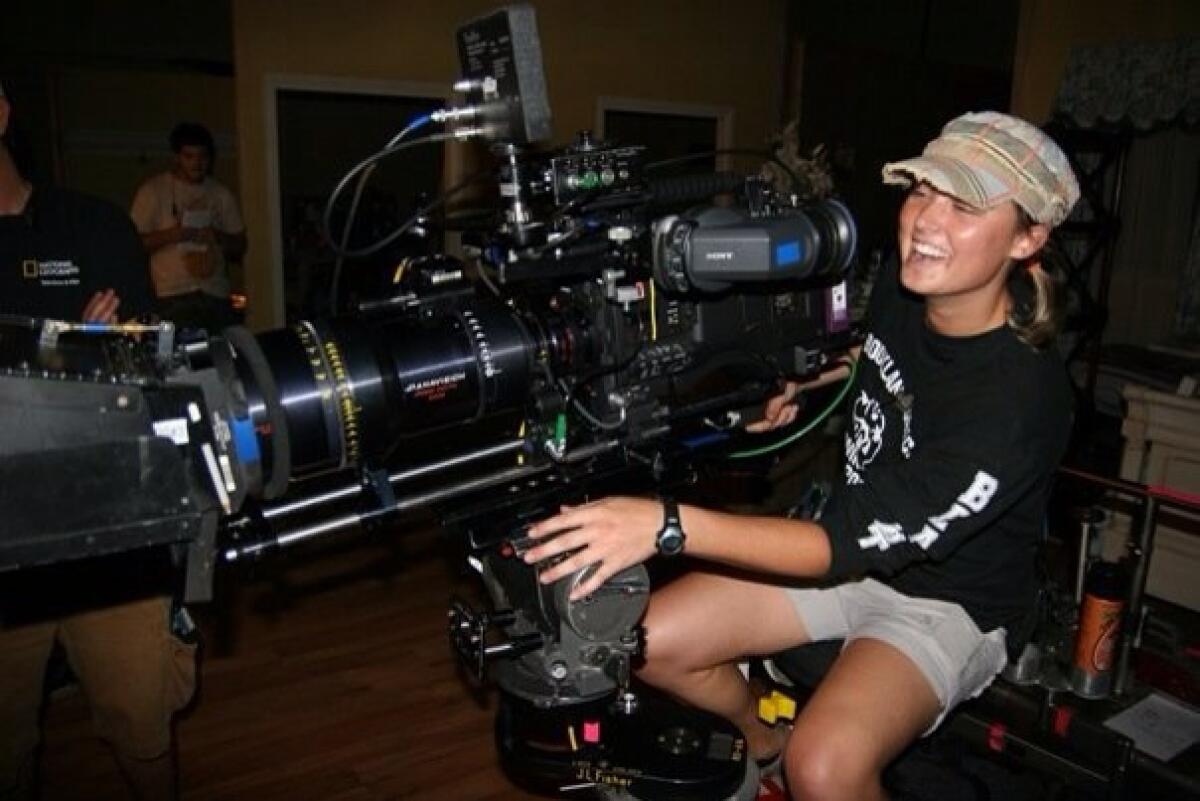 Sarah Jones operates a film camera.