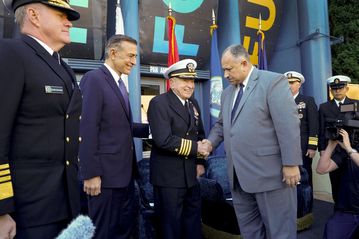 Capt. Royce Williams is congratulated by Secretary of the Navy Carlos Del Toro after he was awarded the Navy Cross.