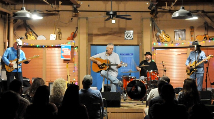 Onstage in August at Oklahoma City’s the Blue Door, the band the Regular Joes, fronted by singer-songwriter Joe Baxter, center, with Randy Cotrell, left, on lead guitar, Bill Conos on drums and Marco Tello on bass.