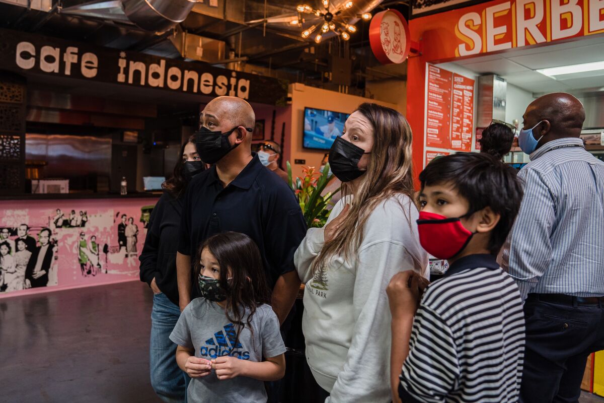 A family checks out the food stalls at Market on 8th in National City on Tuesday.