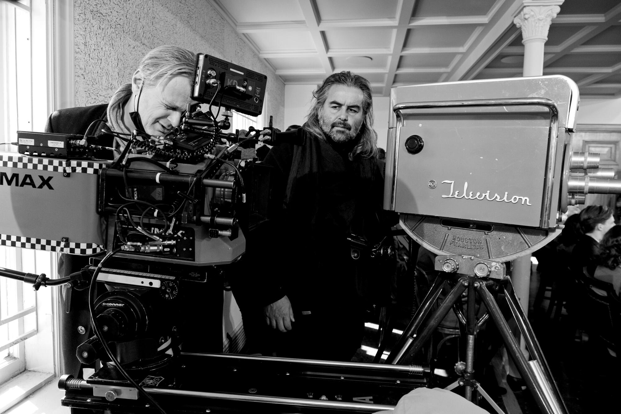 Cinematographer Hoyte van Hoytema and Christopher Nolan with film cameras on the "Oppenheimer" set.