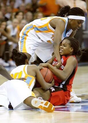 Epiphanny Prince of the Rutgers Scarlet Knights fights to maintain control of the ball against Tennessee's Shannon Bobbitt and Alberta Auguste.