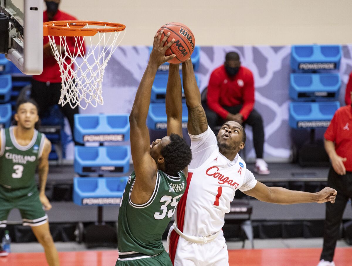 Houston guard Jamal Shead tries to block a shot by Cleveland State forward Deante Johnson.