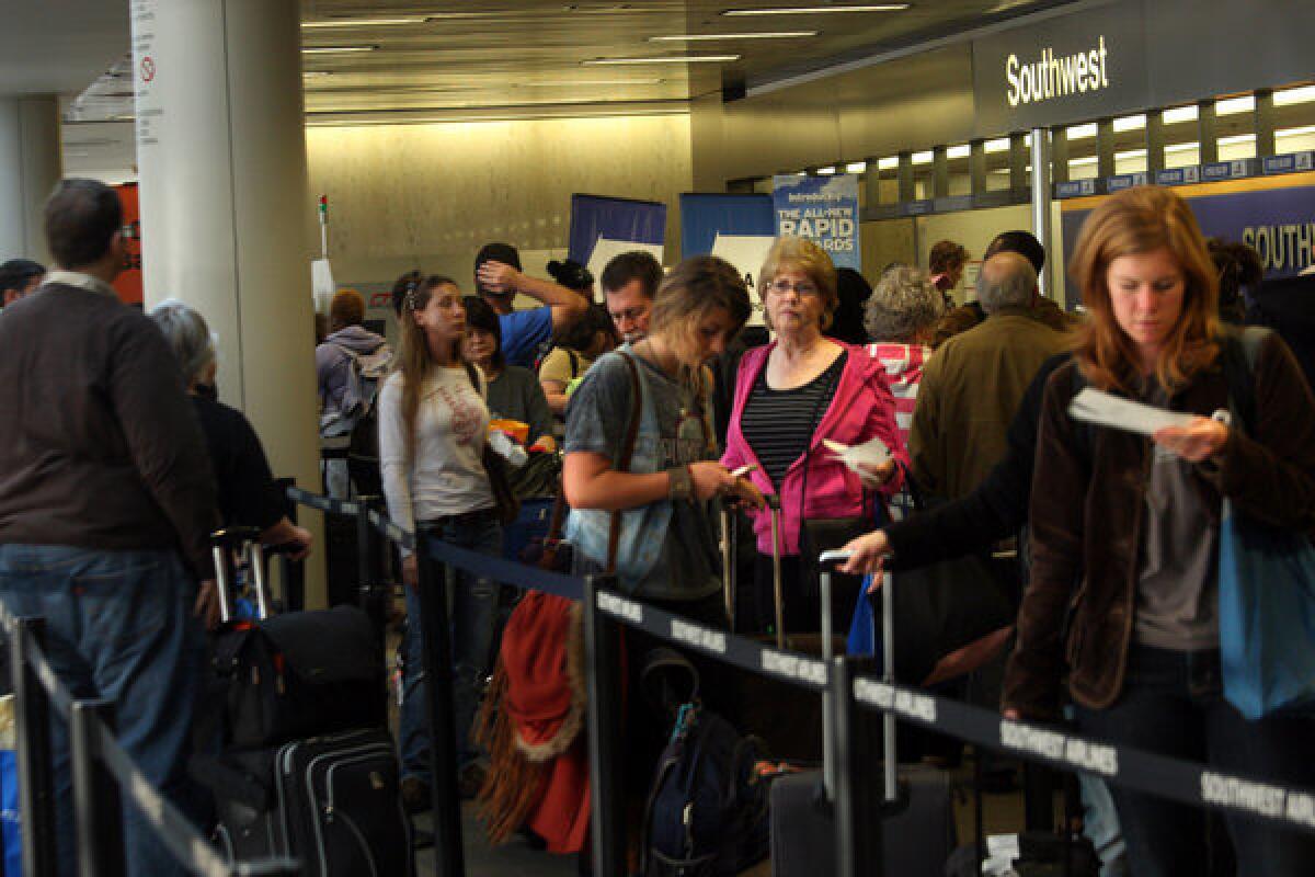 AAA says 7% of Thanksgiving travel will be by airplane this year. Above, Thanksgiving travelers wait to check in at Los Angeles International Airport in 2011.