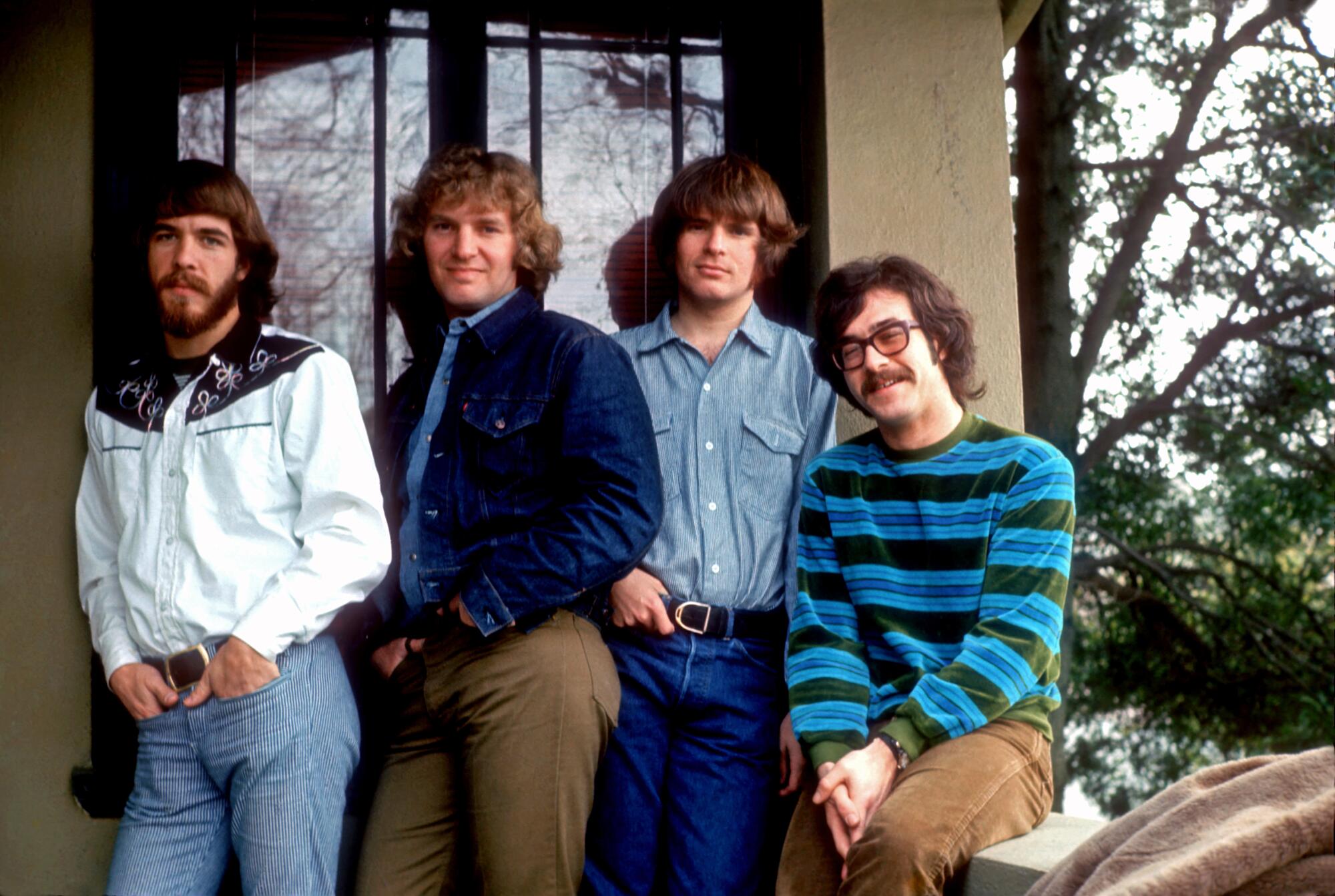 A four-piece rock band pose for a photo, circa 1970.