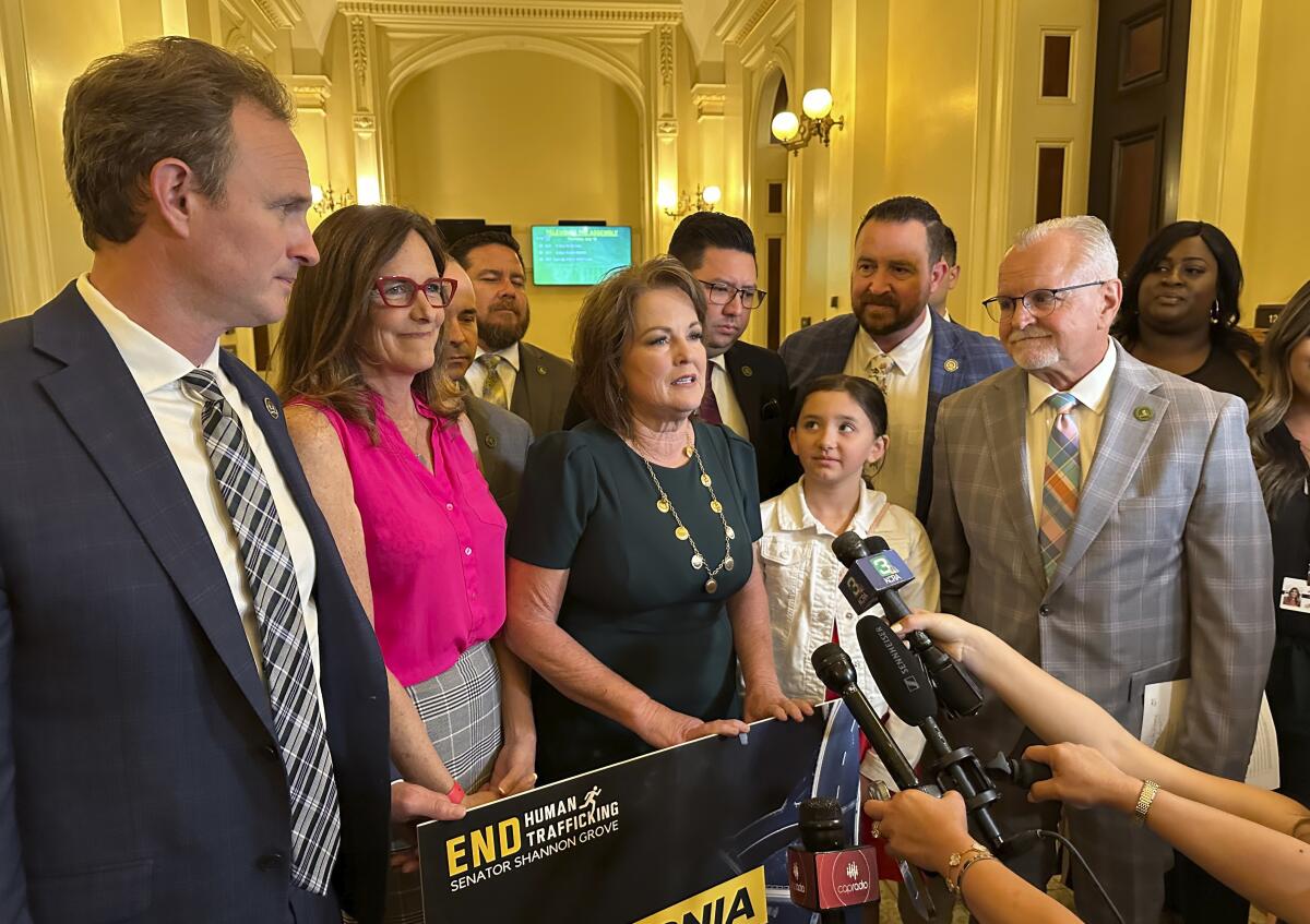 Republican state Sen. Shannon Grove, center, speaks to reporters in Sacramento