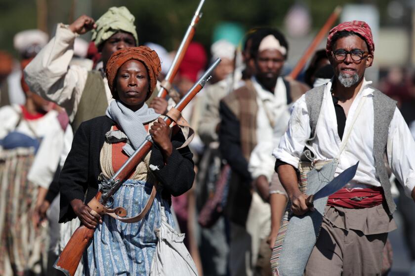 NEW ORLEANS, LOUISIANA - NOVEMBER 09: Reenactors under the direction of performance artist Dread Scott retrace the route of one of the largest slave rebellions in U.S. history on November 09, 2019 in New Orleans, Louisiana. The 1811 uprising of slaves, mostly armed with hand tools, began in southeastern Louisiana, ultimately growing in size to roughly 200 to 500 slaves from sugar plantations in the area. While two whites were killed, confrontations with militia and executions after trial claimed the lives of around 95 blacks. (Photo by Marianna Massey/Getty Images) ** OUTS - ELSENT, FPG, CM - OUTS * NM, PH, VA if sourced by CT, LA or MoD **