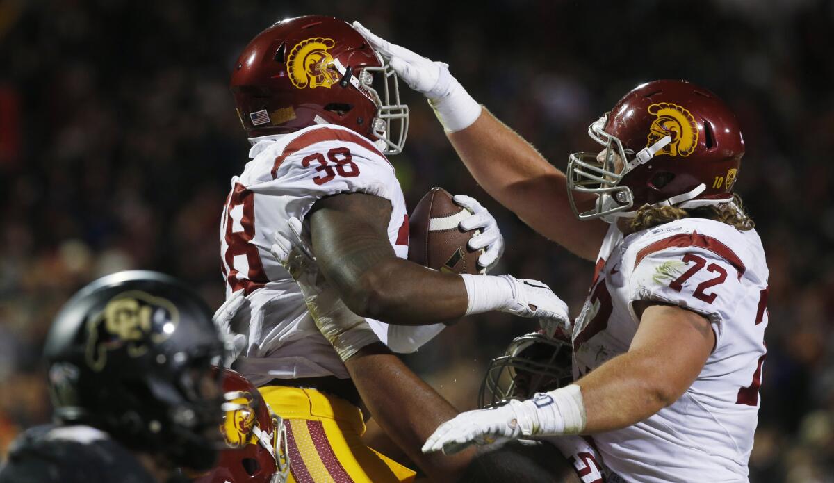 USC fullback Jahleel Pinner (38) celebrates his touchdown catch against Colorado with offensive tackle Chad Wheeler in the second half.