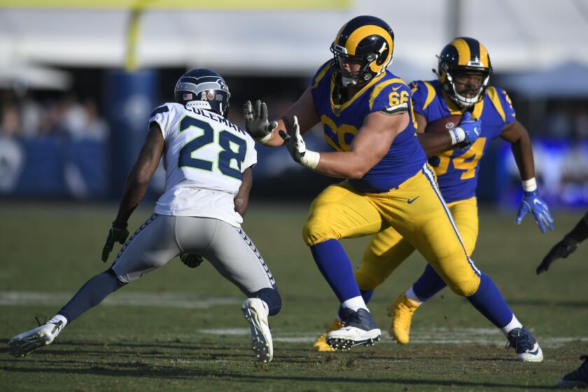 LOS ANGELES, CA - NOVEMBER 11: Austin Blythe #66 of the Los Angeles Rams blocks Justin Coleman #28 of the Seattle Seahawks to allow Malcolm Brown #34 room to run at Los Angeles Memorial Coliseum on November 11, 2018 in Los Angeles, California. (Photo by John McCoy/Getty Images)