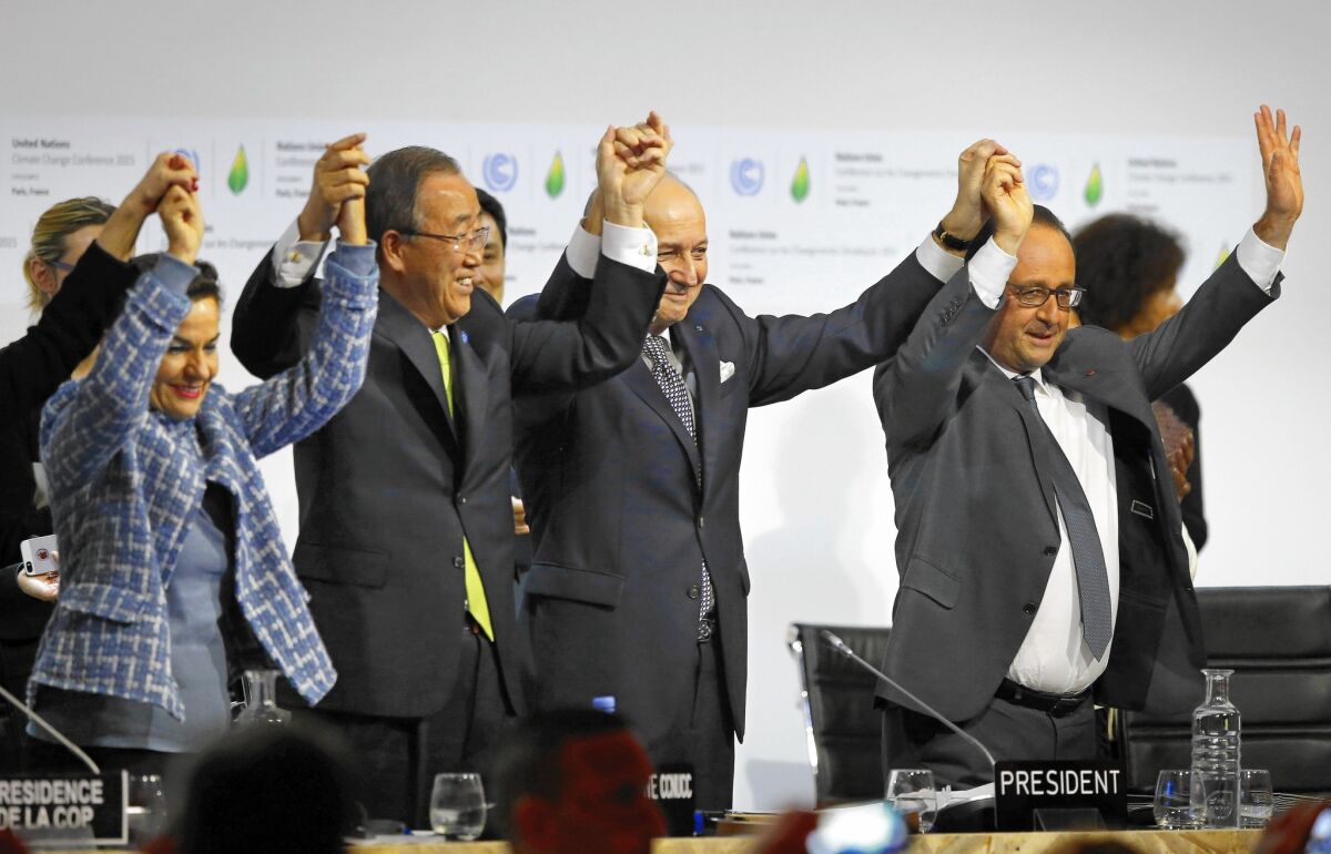 Officials, including then-U.N. Secretary-General Ban Ki-moon, second from left, celebrate the Paris agreement in 2015.