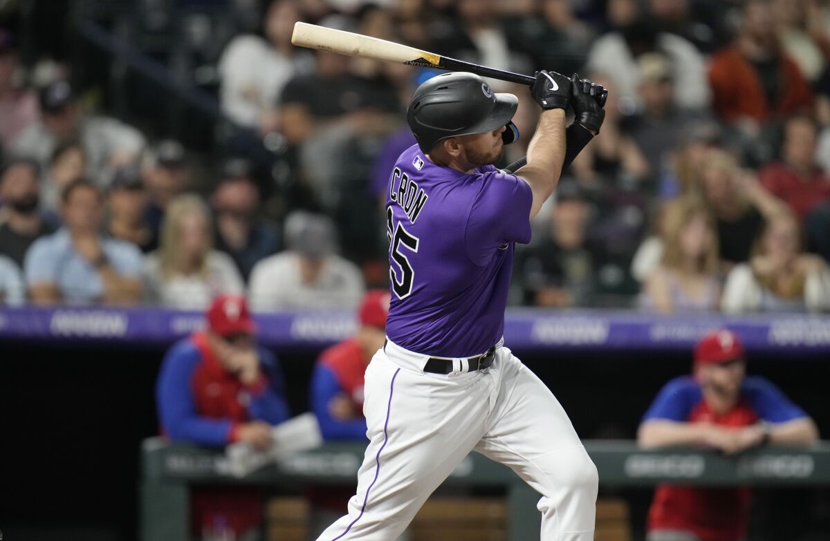 Colorado Rockies' C.J. Cron watches his three-run home run off Philadelphia Phillies relief pitcher Jeurys Familia during the seventh inning of a baseball game Tuesday, April 19, 2022, in Denver. (AP Photo/David Zalubowski)