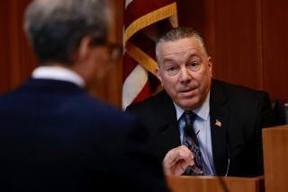 LOS ANGELES CA JANUARY 12, 2024 - Former L.A. County Sheriff Alex Villanueva, right, testifies at the Sheriff's Civilian Oversight Commission meeting, where he answered questions under oath about deputy gangs on Friday, January 12, 2024. (Irfan Khan / Los Angeles Times)