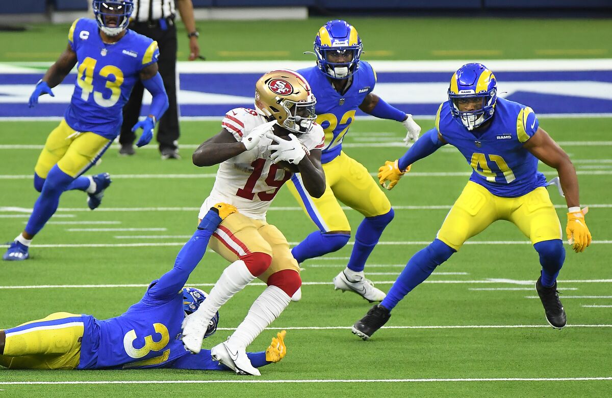 San Francisco 49ers wide receiver Deebo Samuel picks up yards against the Rams in the fourth quarter Sunday.