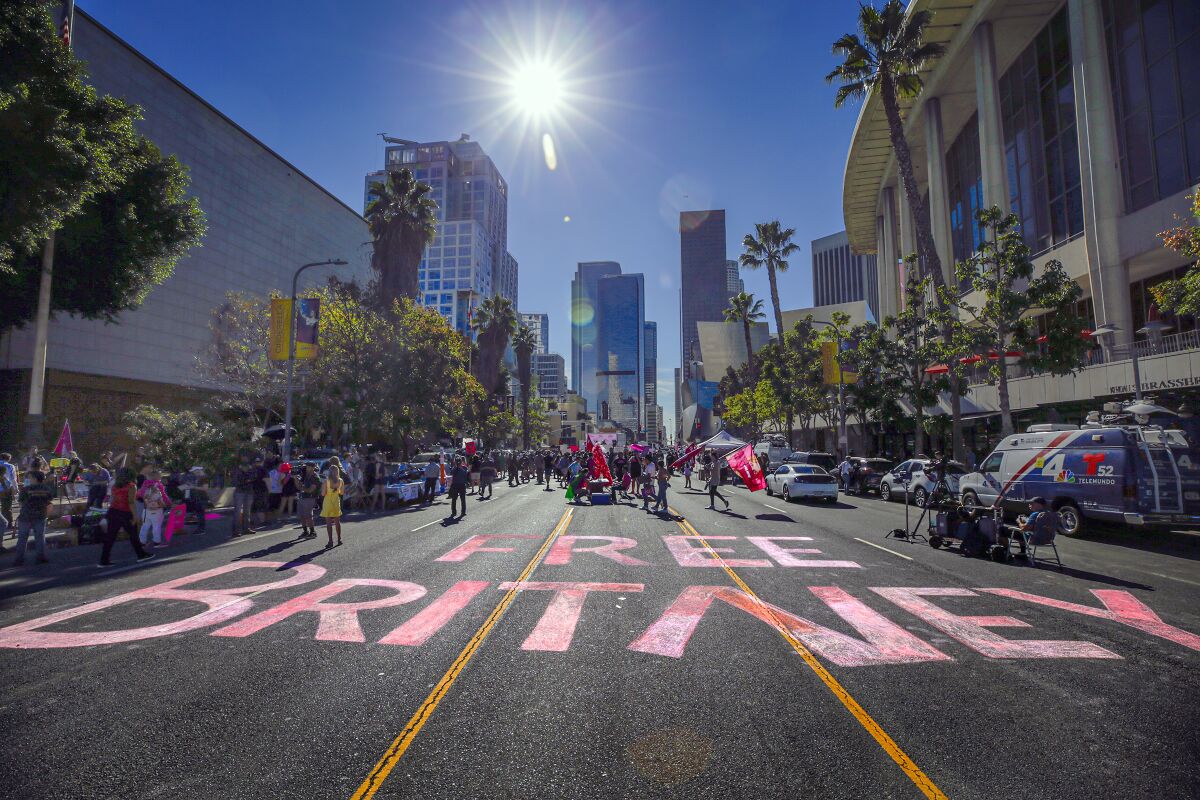The words Free Britney are painted on a downtown street