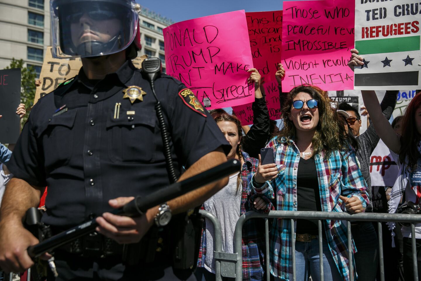 Trump protesters are blocked by police outside the California Republican Convention.