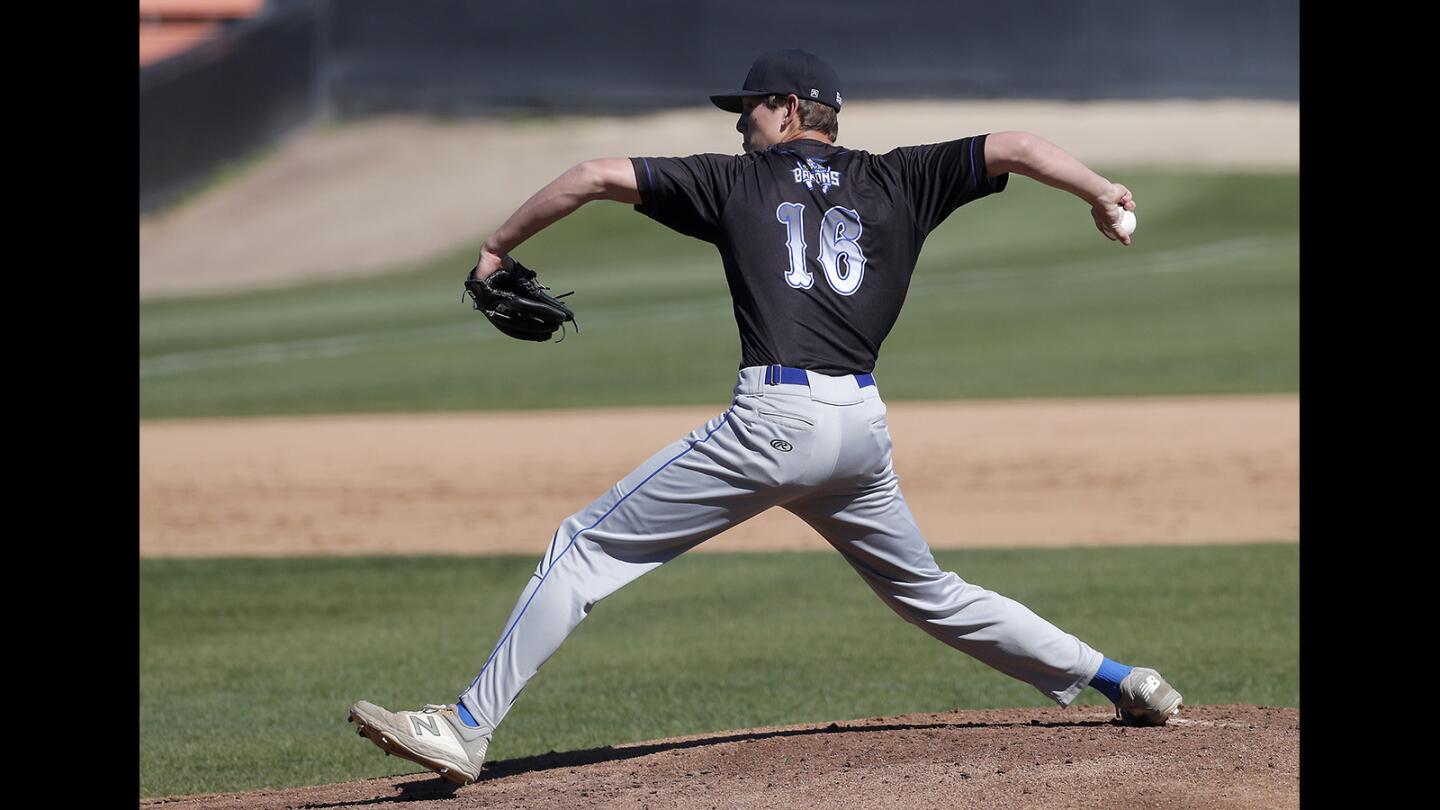 Fountain Valley High starter Jake Brooks throws against Huntington Beach during the first inning in a Surf League game at Huntington Beach High on Friday, March 15, 2019.