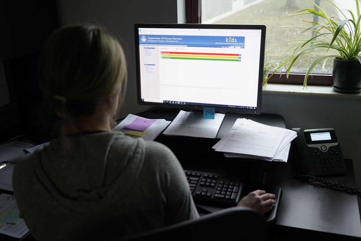 FILE - Case work supervisor Jessie Schemm looks over the first screen of software used by workers who field calls at an intake call screening center for the Allegheny County Children and Youth Services, in Penn Hills, Pa. The Justice Department has been scrutinizing a controversial artificial intelligence tool used by a Pittsburgh-area child protective services agency following concerns that it could result in discrimination against families with disabilities, The Associated Press has learned. (AP Photo/Keith Srakocic, File)