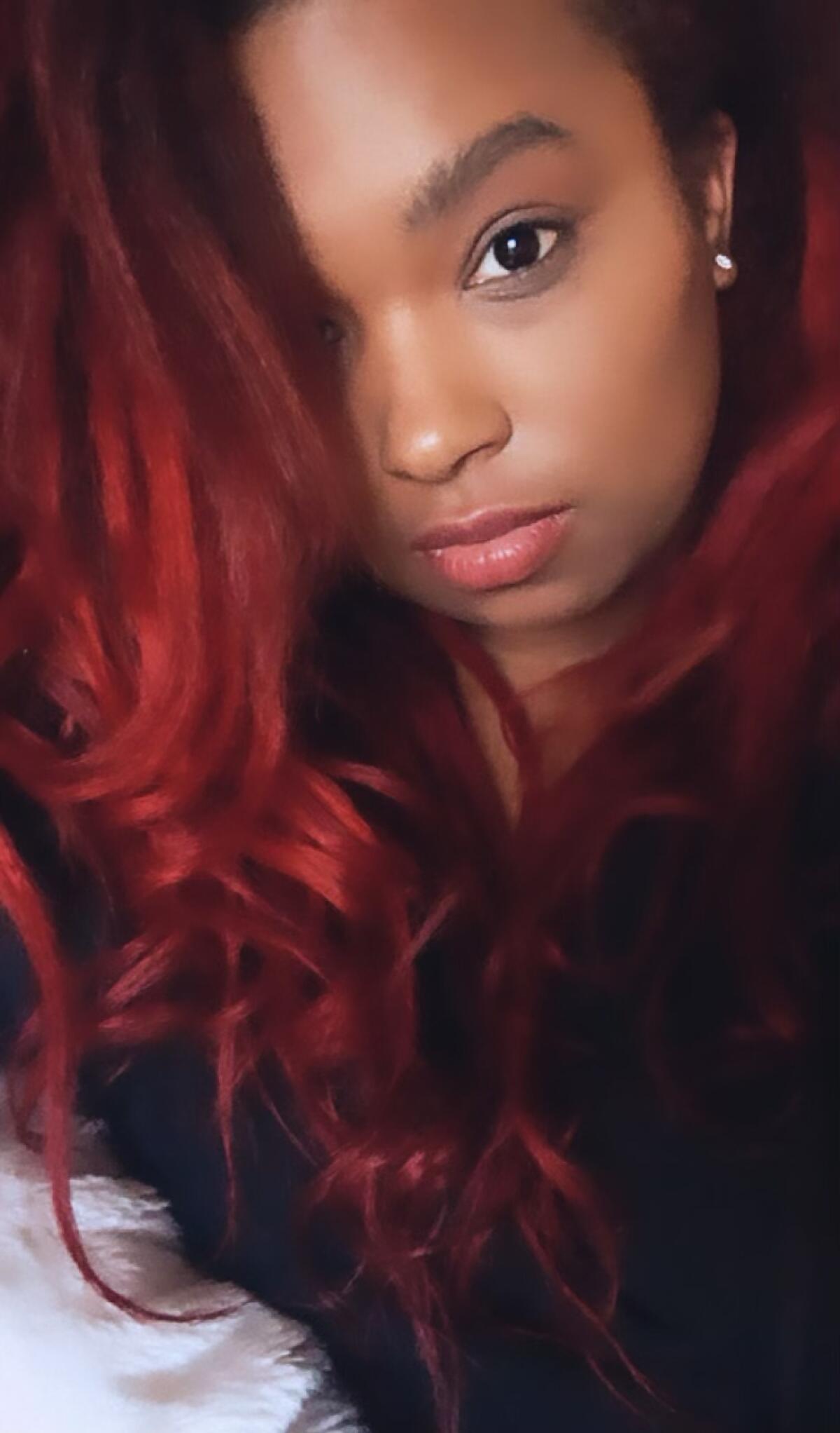 A woman's face and red hair.