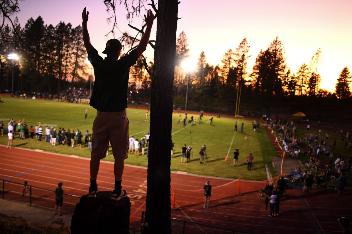 Fans watch the high school football team in Paradise