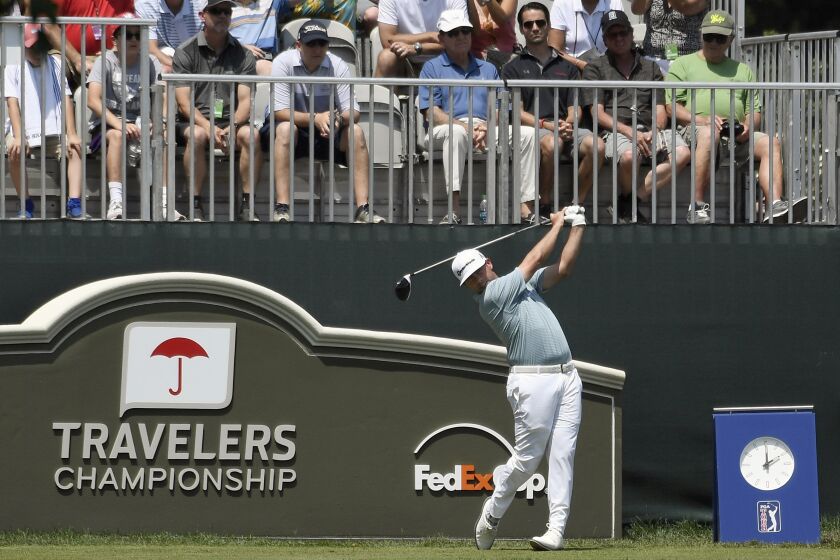 FILE - In this June 23, 2019, file photo, Chez Reavie hits off the first tee during the final round of the Travelers Championship golf tournament in Cromwell, Conn. The PGA Tour heads north to Connecticut with another strong field. The Travelers Championship at the TPC River Highlands has attracted nine of the top 10 players in the world. (AP Photo/Jessica Hill, File)
