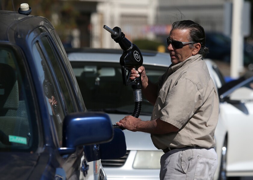 A customer prepares to pump gasoline into his car at an Arco gas station on March 3, 2015, in Mill Valley, Calif.