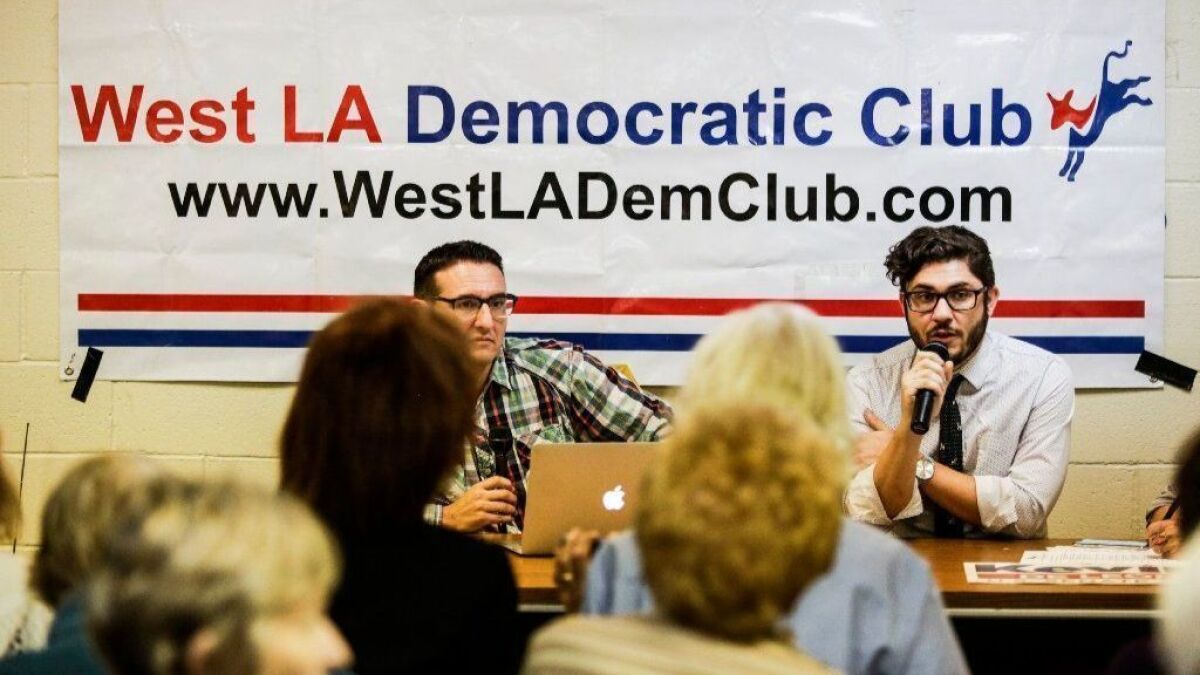 David Jette, right, legislative director of the advocacy group Public Bank L.A., speaks in favor of Measure B at a West Los Angeles Democratic Club meeting last month.