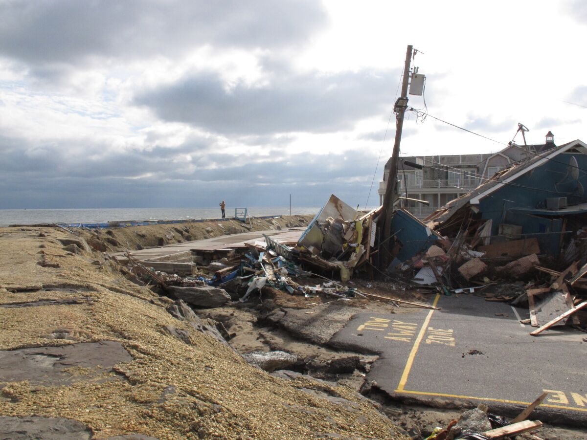 This Nov. 15, 2012 photo shows the remnants of an oceanfront building in Sea Bright N.J. that was destroyed by Superstorm Sandy. On Thursday, Oct. 15, 2020, New Jersey officials released a report committing the state to try to reduce its greenhouse gas emissions by 80% by the year 2050 to help fight climate change and rising sea levels. (AP Photo/Wayne Parry)