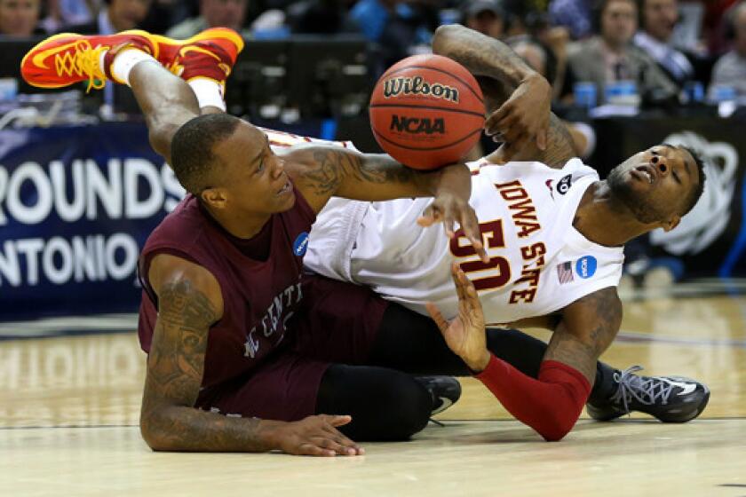 North Carolina Central's Alfonzo Houston, left, battles Iowa State's DeAndre Kane for a loose ball during the Cyclones' 93-75 win Friday in the second round of the NCAA tournament.