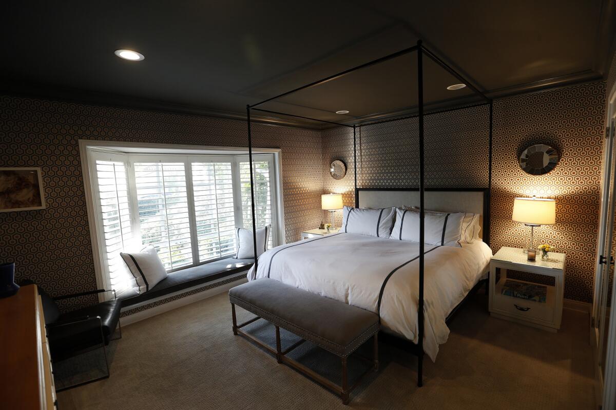 The master bedroom after decorating, at left are shutters with a newly covered, velvet window seat. (Mel Melcon / Los Angeles Times)