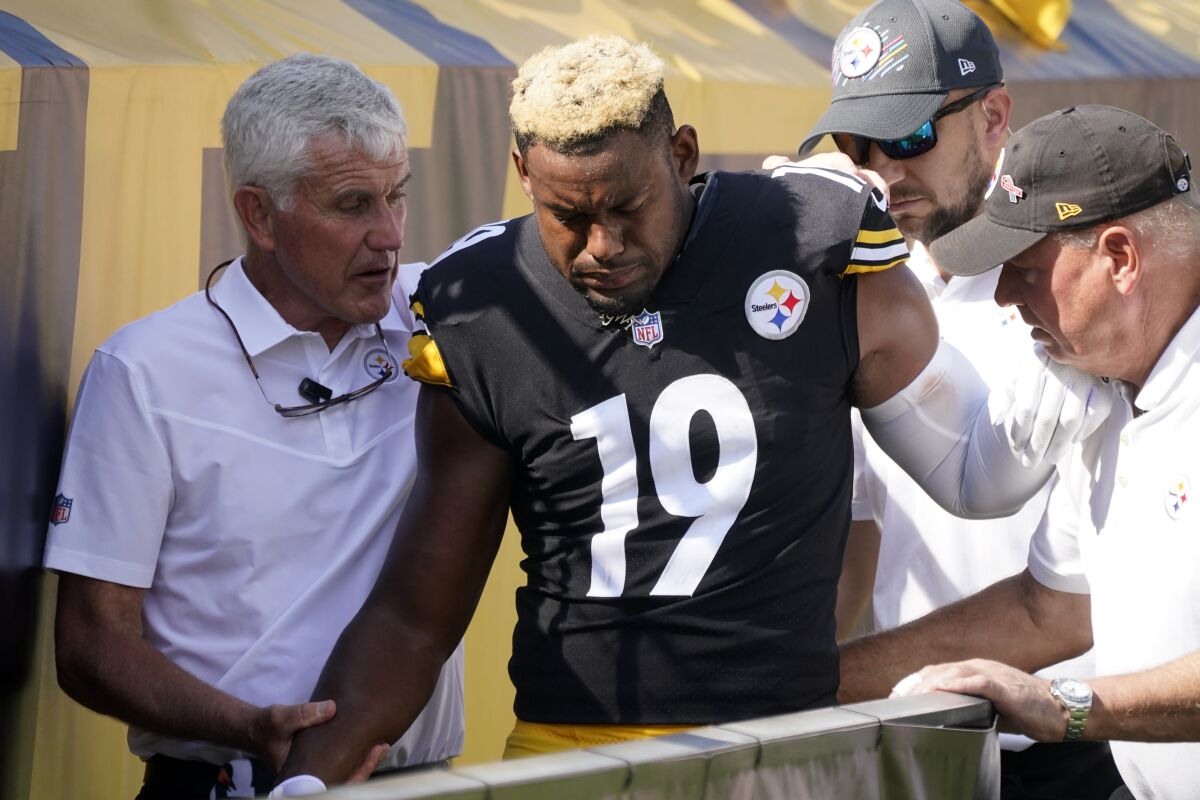Pittsburgh Steelers wide receiver JuJu Smith-Schuster (19) is helped off the field after being injured during the first half of an NFL football game against the Denver Broncos in Pittsburgh, Sunday, Oct. 10, 2021. (AP Photo/Keith Srakocic)